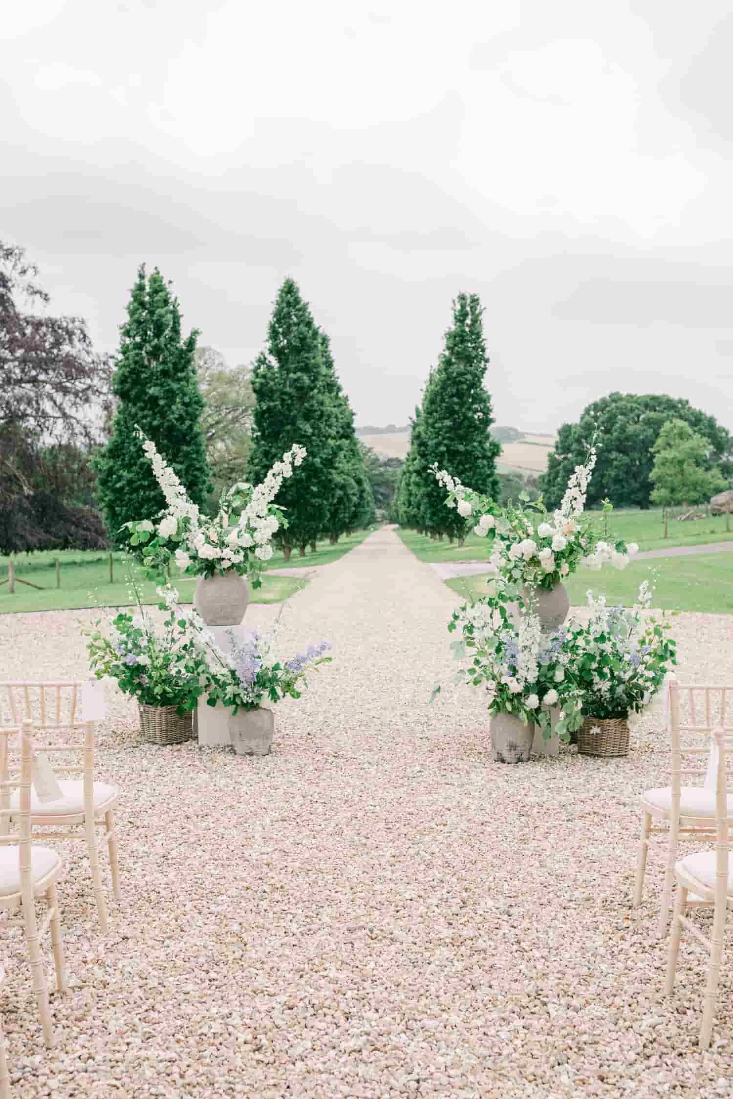 Outdoor flower vase installations for wedding at Pynes House