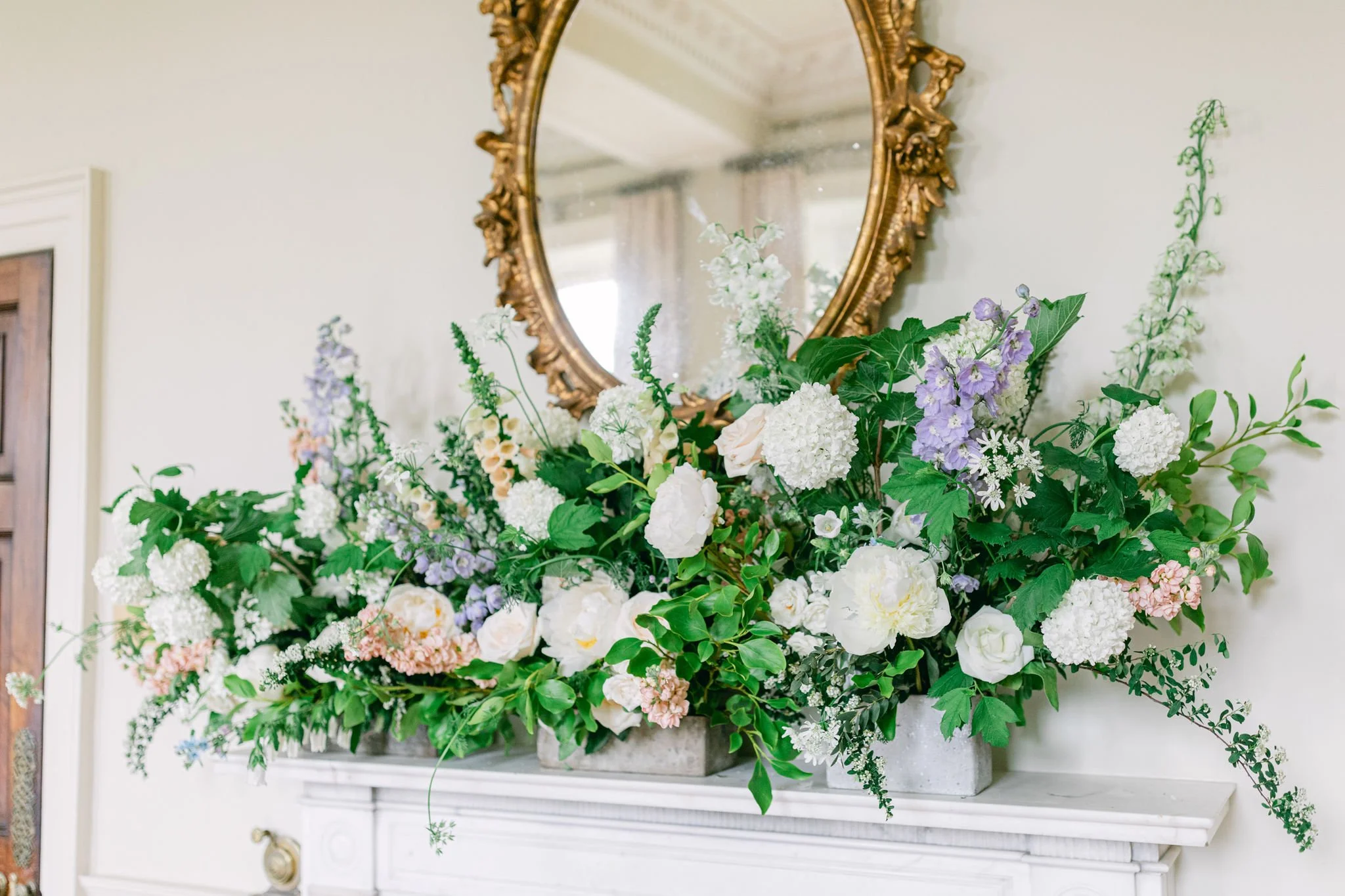 blush and pale blue seasonal flower mantelpiece in Pynes House dining room