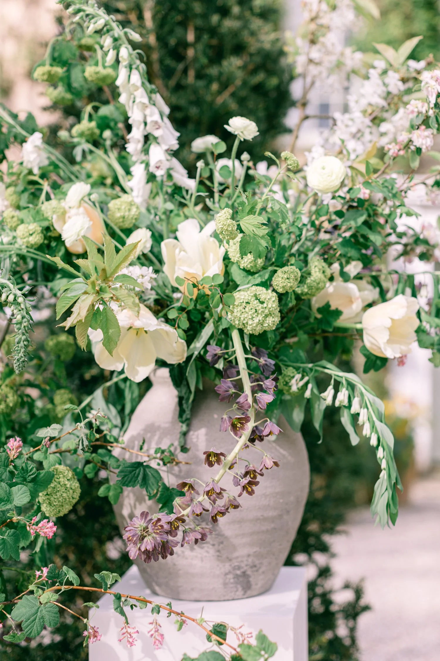 stone statement vase full of natural spring seasonal flowers for wedding ceremony at South Devon venue