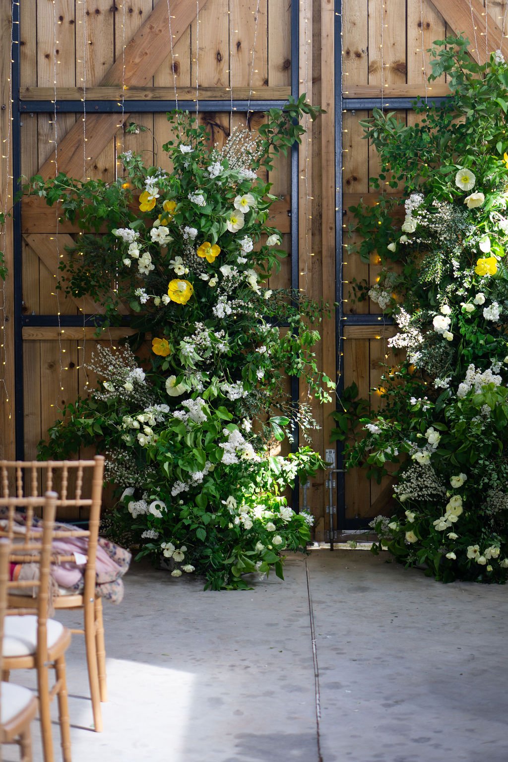 broken flower arch in a natural and elegant design full of seasonal flowers and foliage at Pirzwell Barn