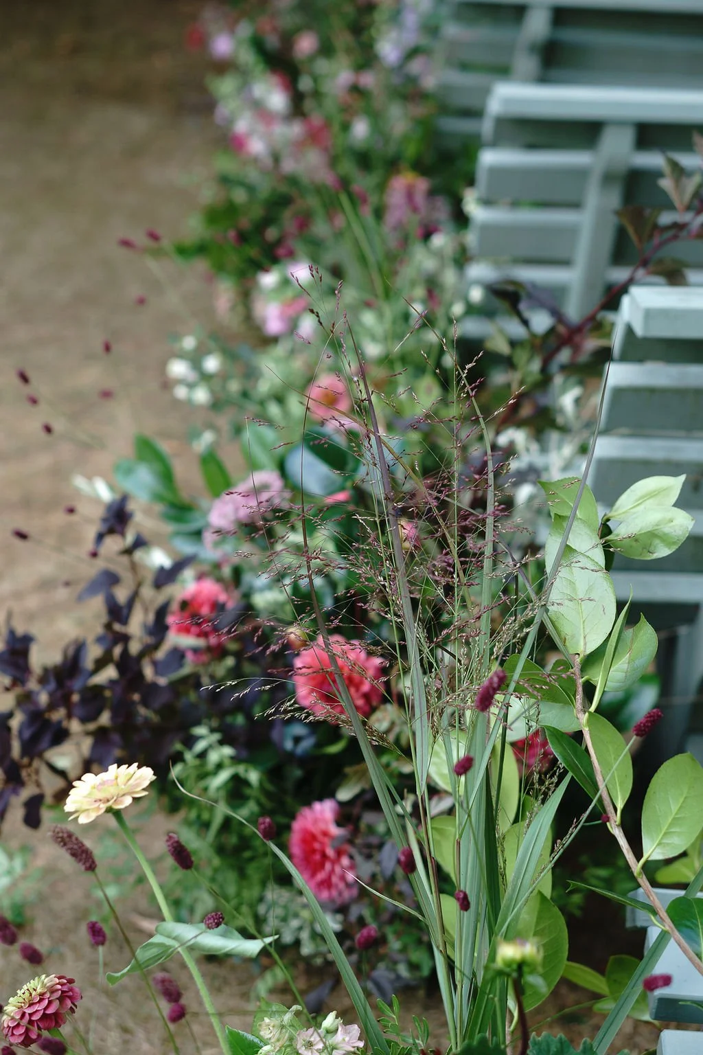 seasonal summer meadow flower aisle for outdoor wedding ceremony at Huntsham Court