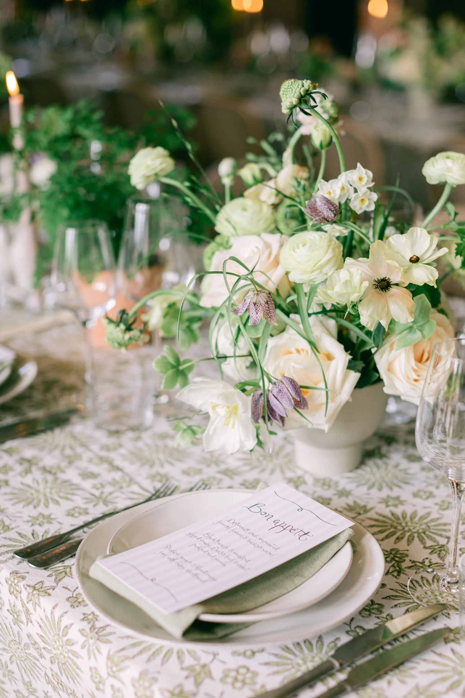 low ceramic bowl full of natural and elegant spring flowers in blush and green on patterned linen