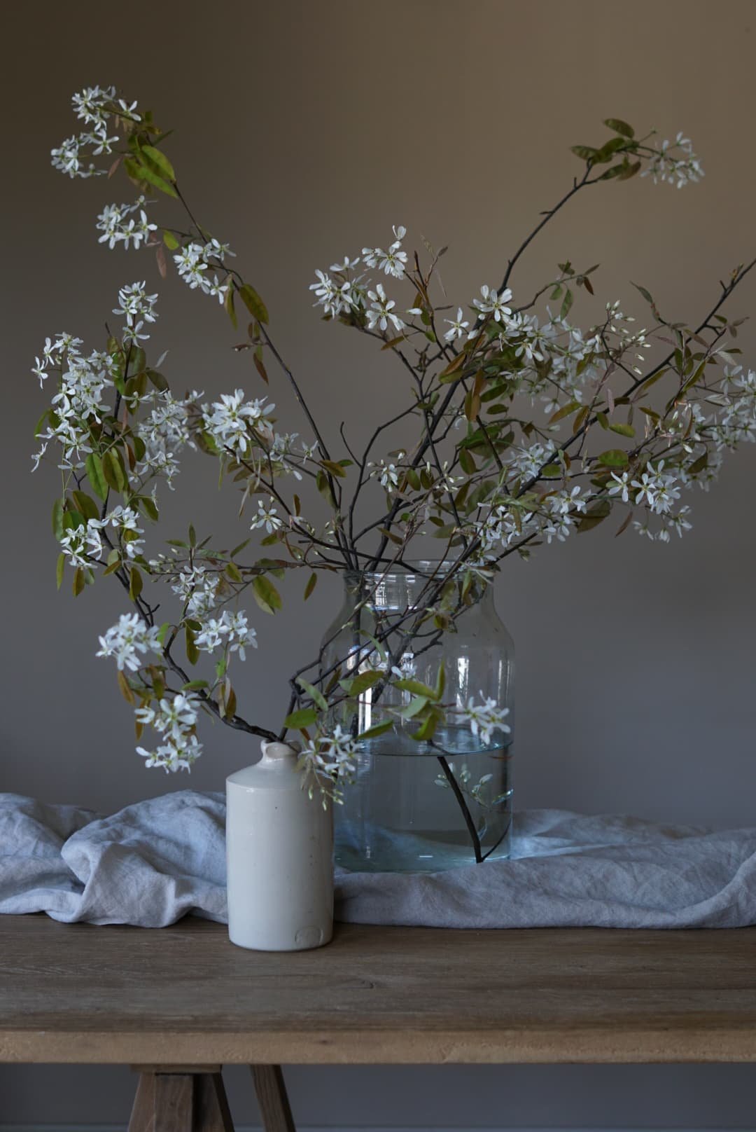 glass vase of locally grown Devon amelanchier foliage