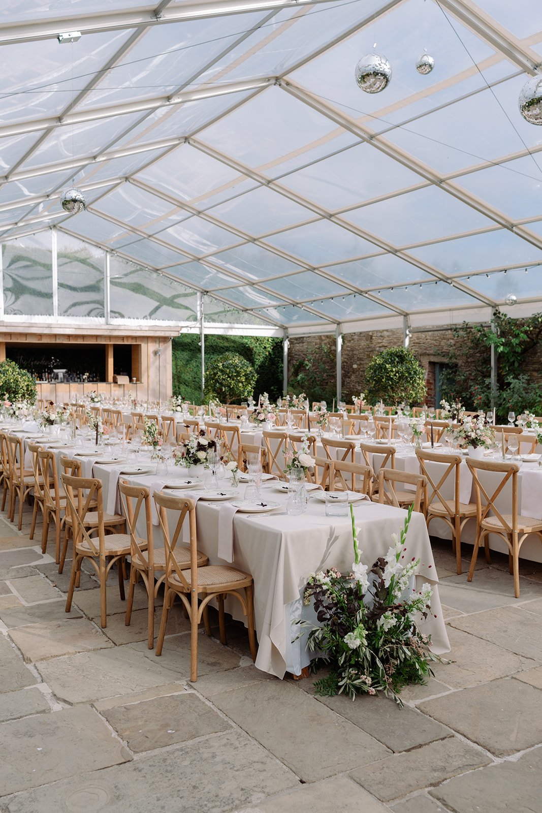 late summer ivory, blush and burgundy wedding flowers on long banquet tables at Kingston Estate with coloured taper candles