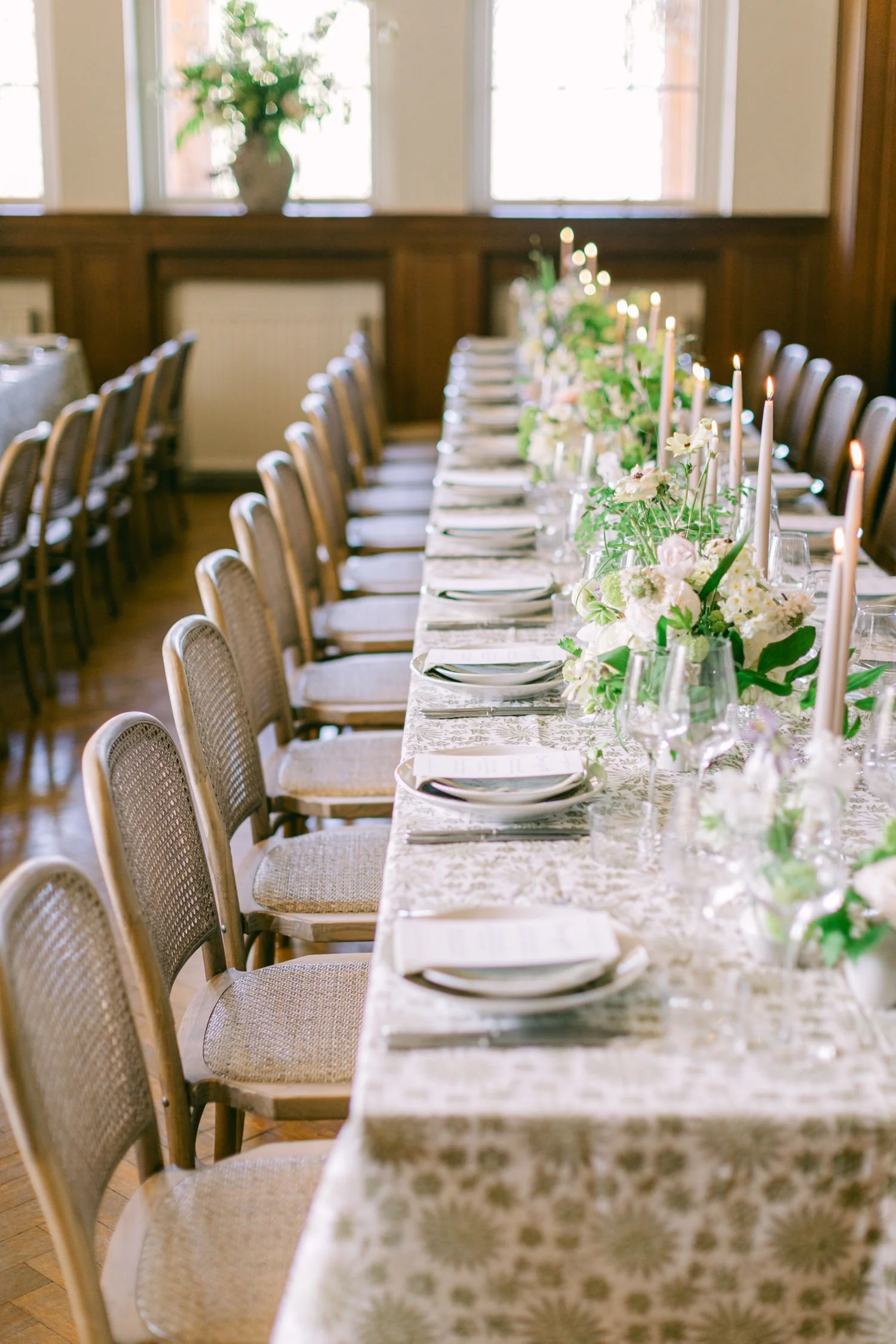 Lost Music Hall wedding tablescape of spring flower arrangements and pattern linen