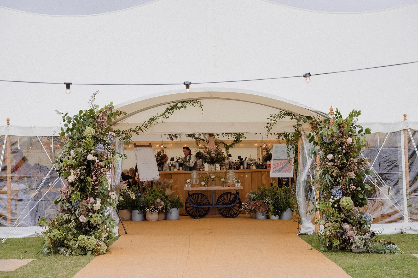 marquee wedding entrance with statement seasonal flower archway