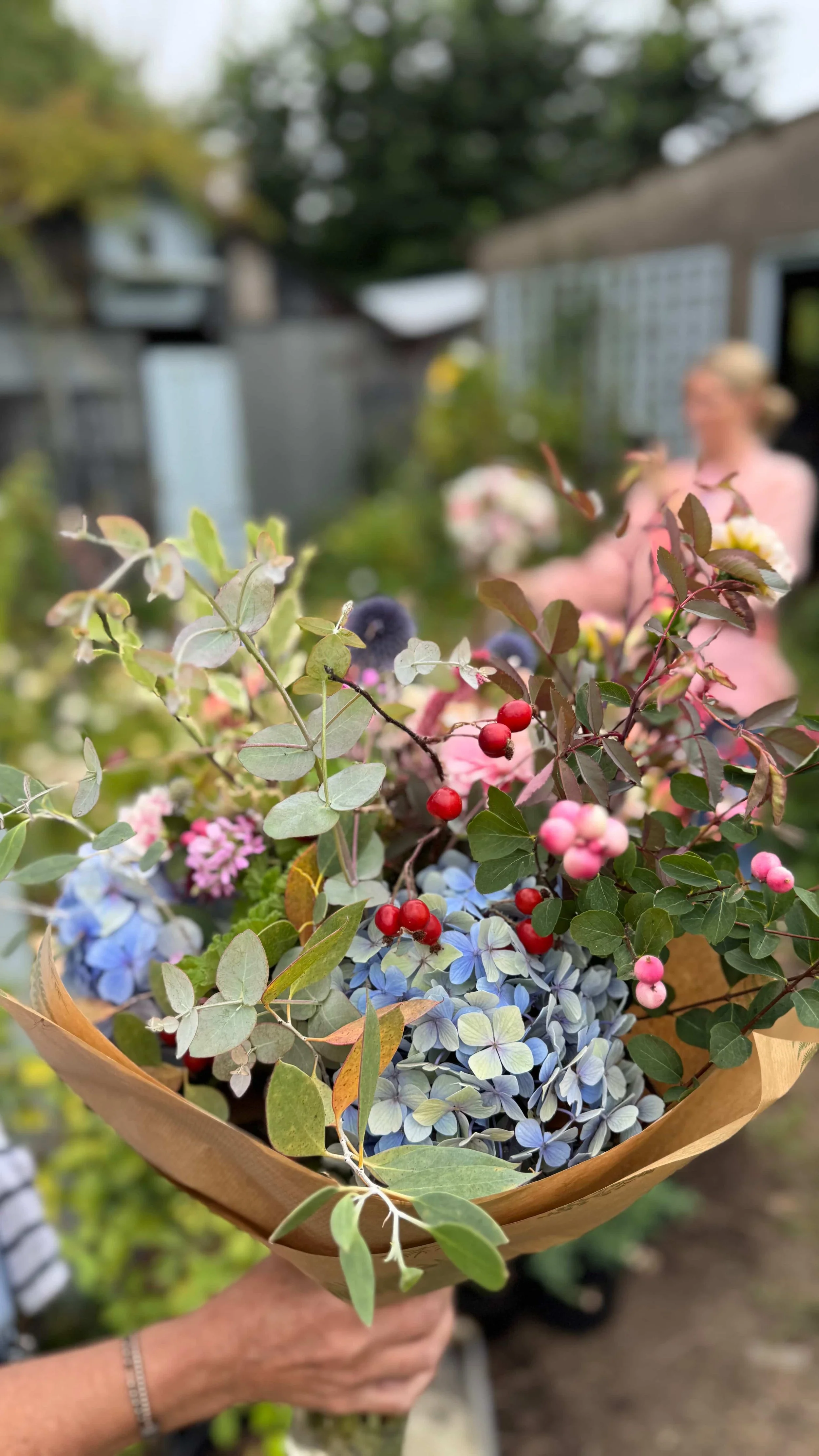 seasonal bouquet of blue hydrangeas eucalyptus and snowberry