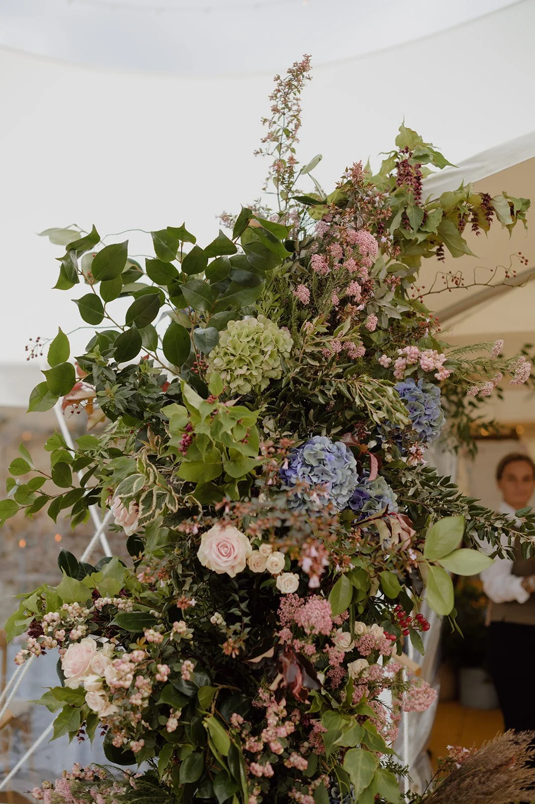 September seasonal wedding flowers in marquee entrance archway