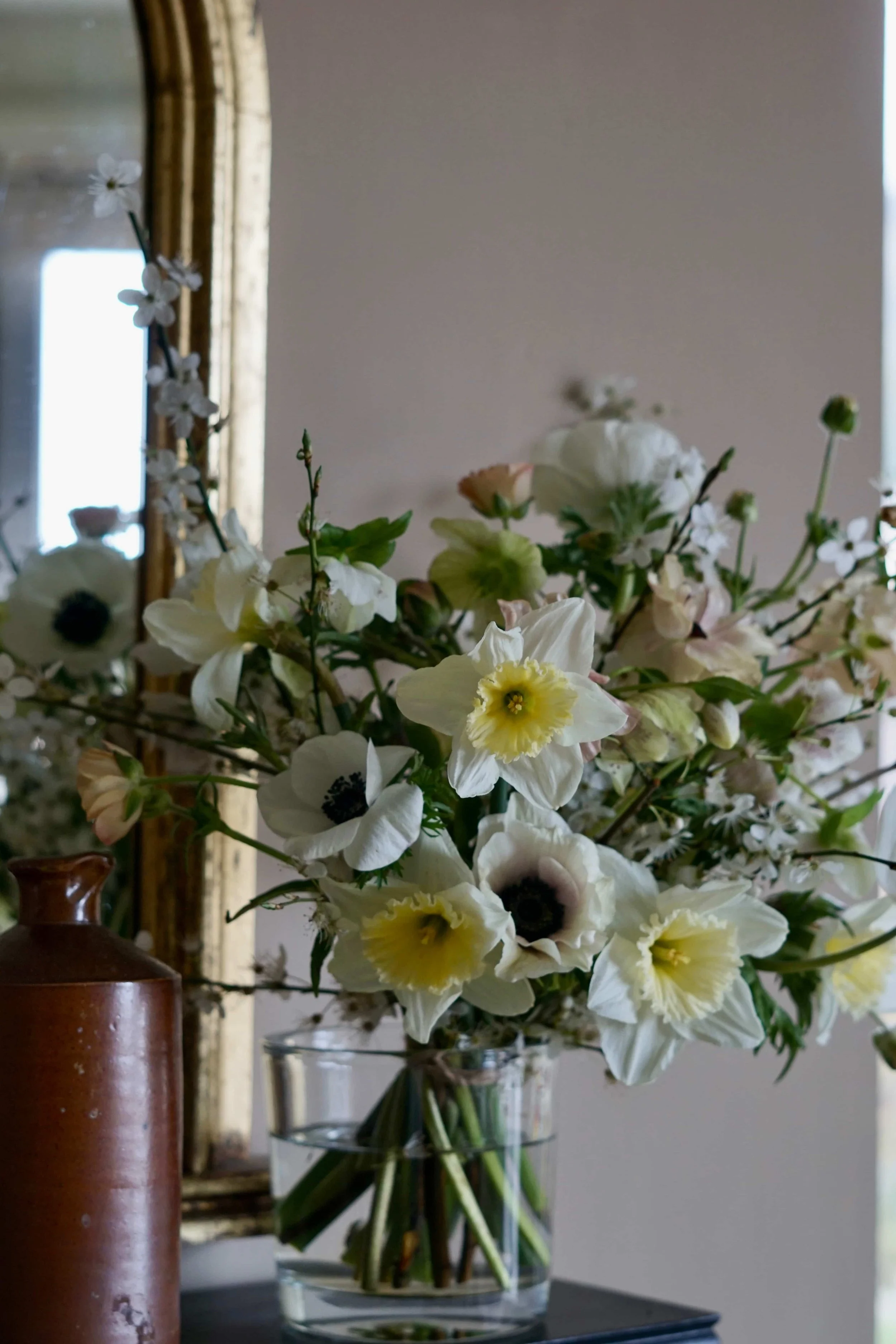 pretty pastel spring Easter vase full of British grown narcissi, ranunculus, anemone and hellebores