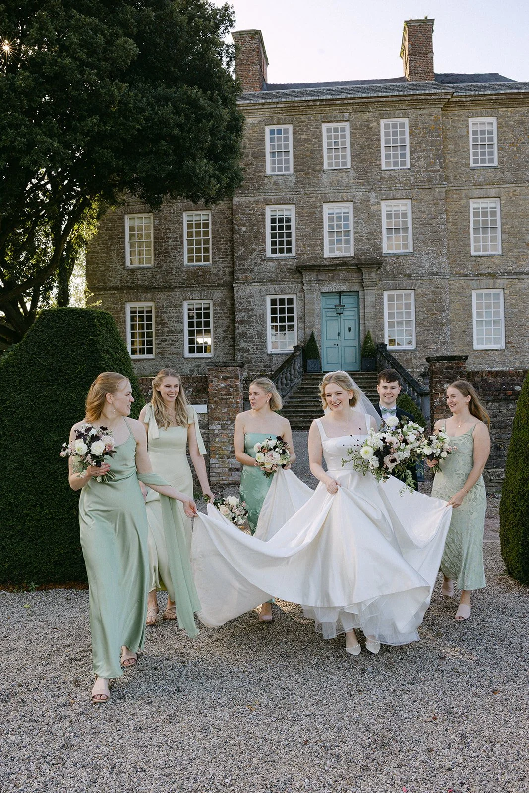 bride and bridesmaids in sage green dresses with autumn bouquets at Kingston Estate