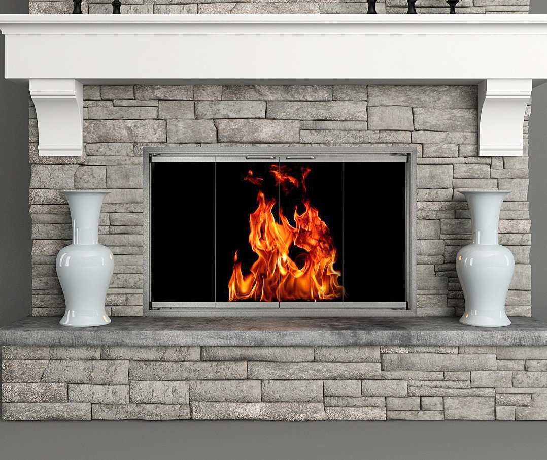 Two white vases on each side of a stone fireplace with a fire burning behind glass doors.