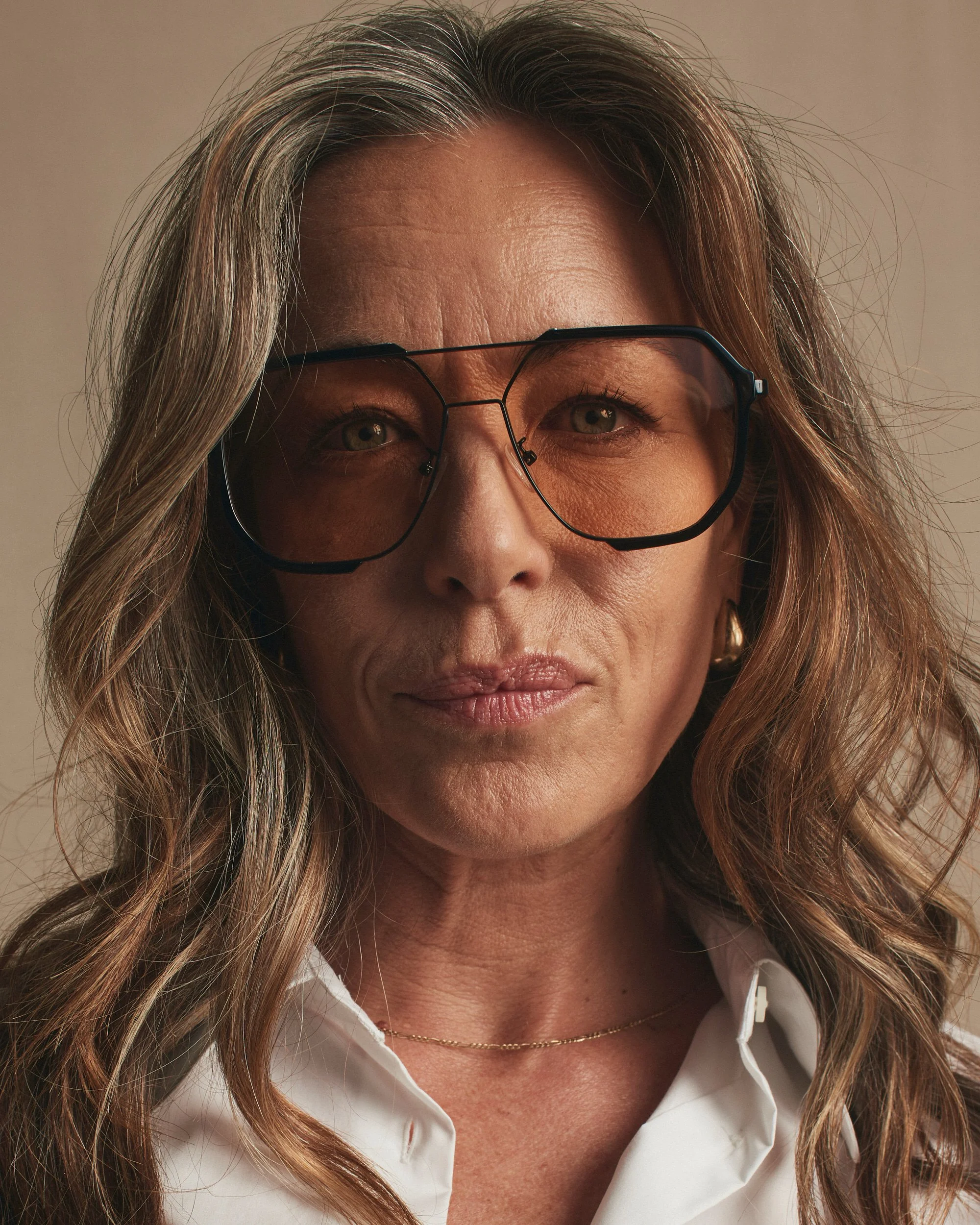 Joshua Pestka commercial beauty photography — Mary Kay TimeWise Repair campaign, close-up portrait with wavy hair, natural skincare glow, sunglasses