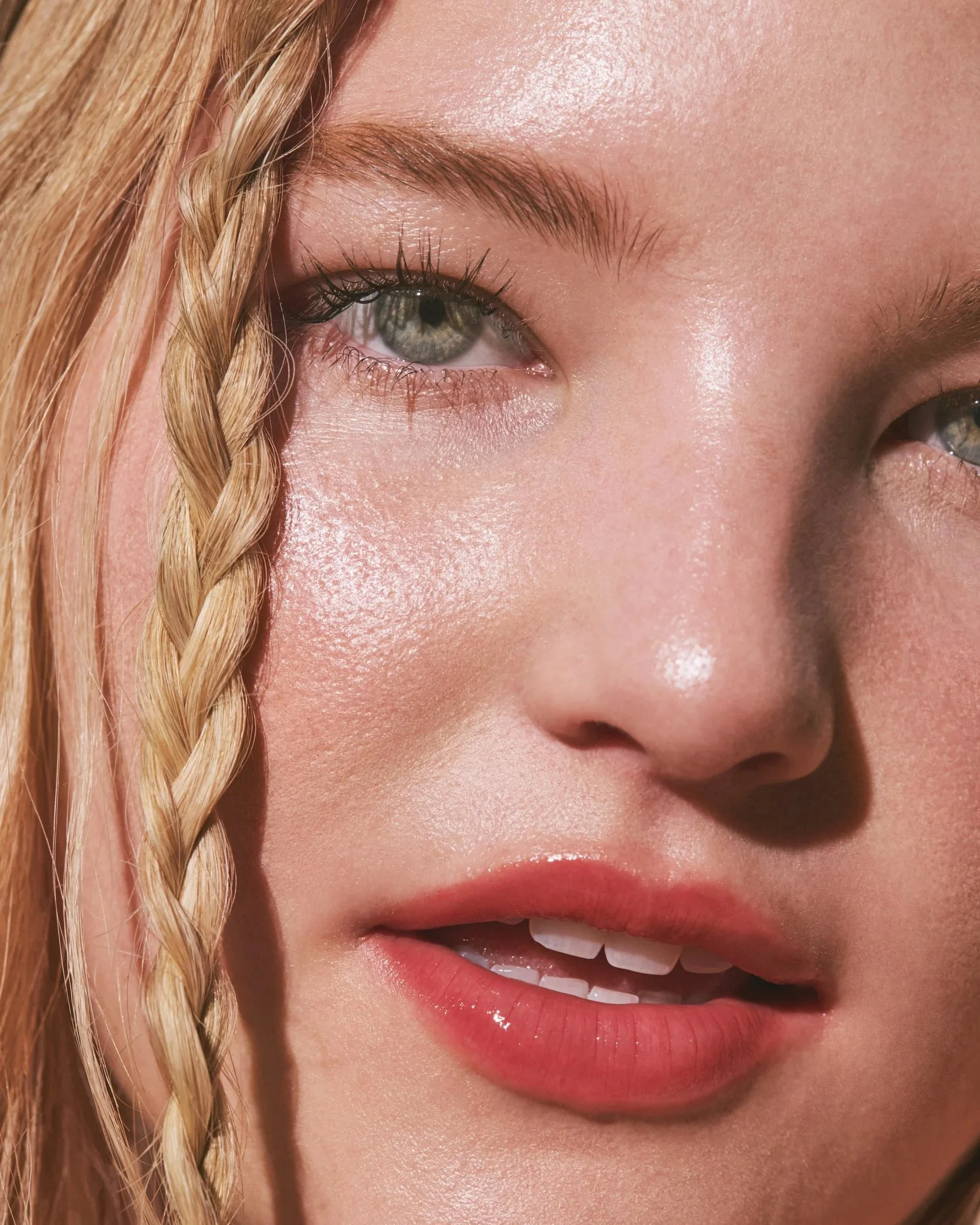 Joshua Pestka commercial beauty photography — Well People Skinphoria campaign, extreme close-up of braided hair, freckled skin and glossy pink lip