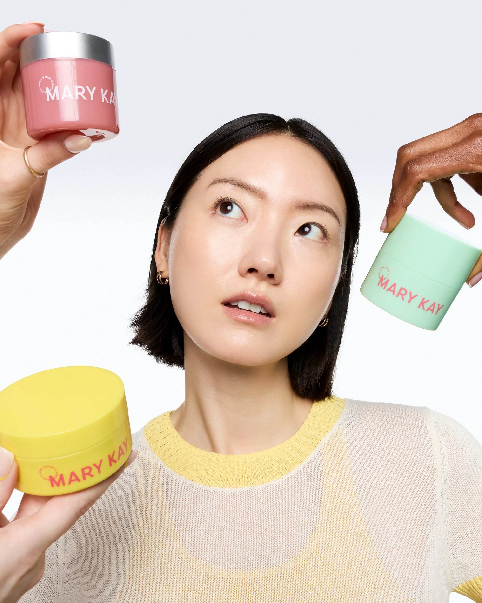 joshua-pestka-mary-kay-k-beauty-hands-holding-jars-around-dark-bob-model.jpg
