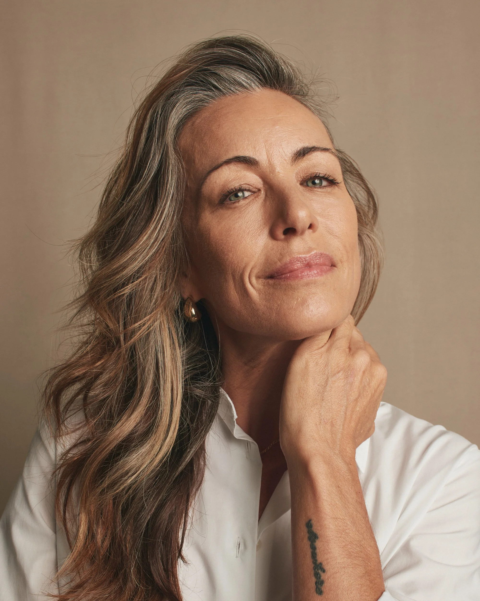 Joshua Pestka commercial beauty photography — Mary Kay TimeWise Repair campaign, close-up portrait with wavy hair, natural skincare glow, small smile
