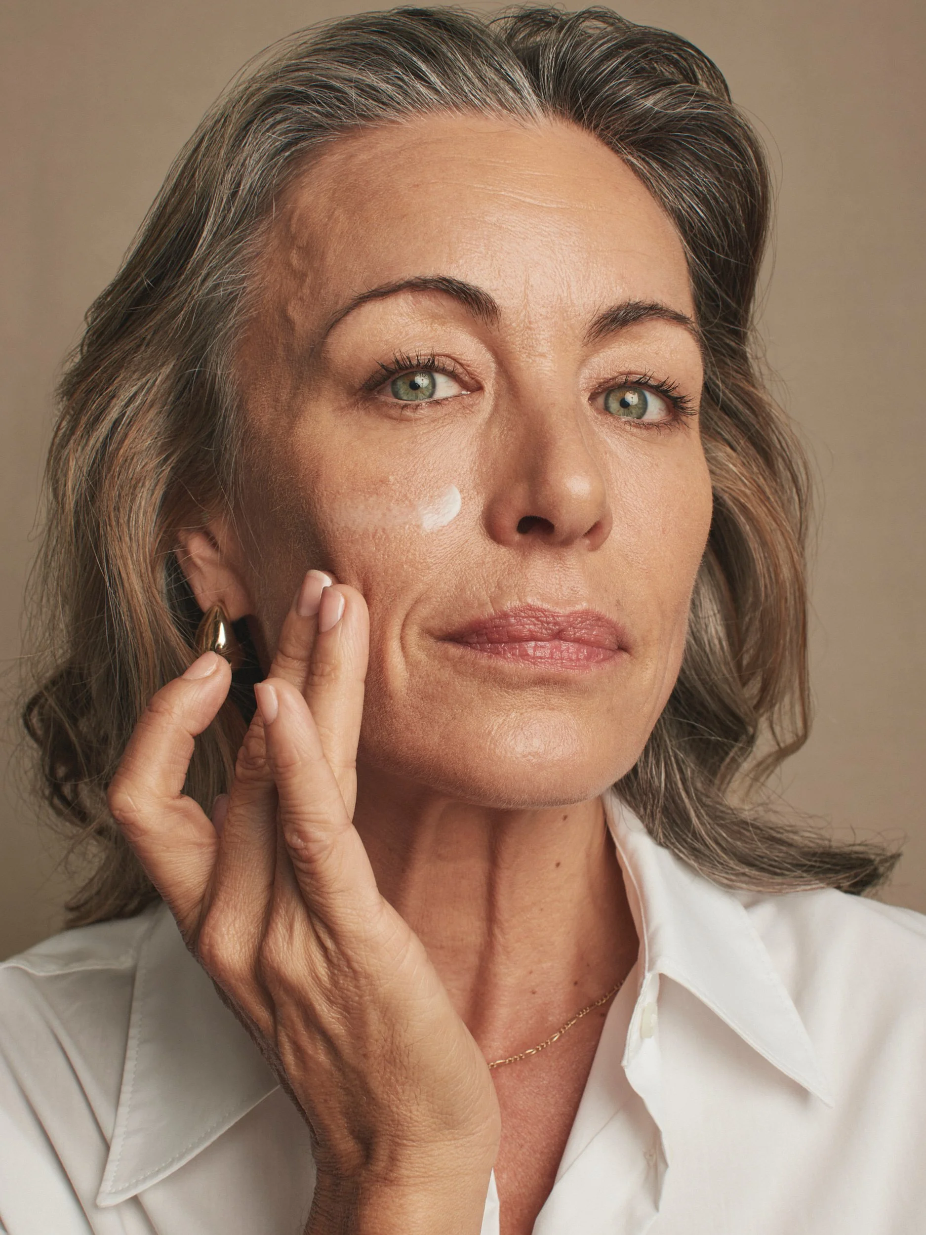 Joshua Pestka commercial beauty photography — Mary Kay TimeWise Repair campaign, model applying serum to face, natural skincare glow