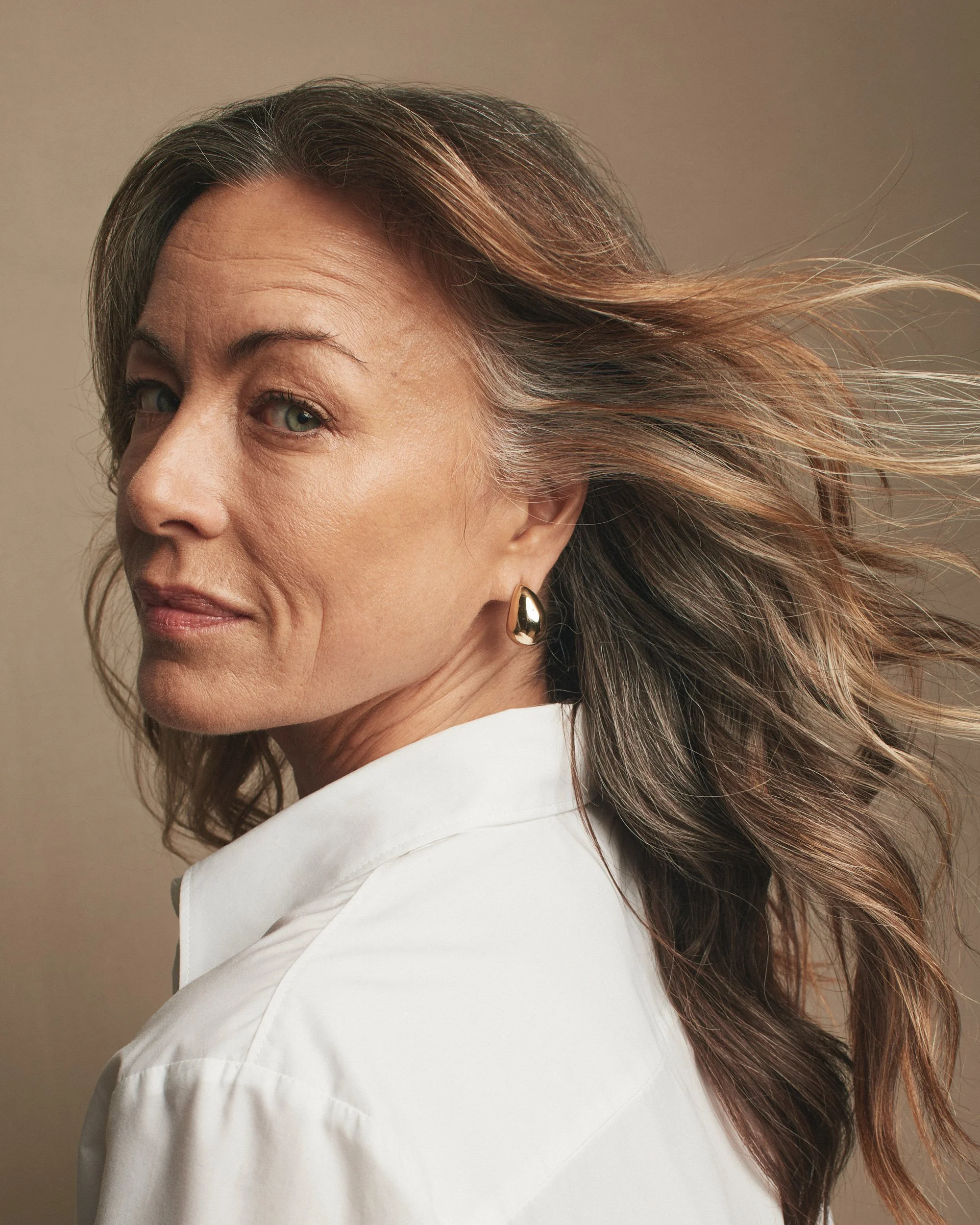 Joshua Pestka commercial beauty photography — Mary Kay TimeWise Repair campaign, close-up portrait with wavy hair, natural skincare glow