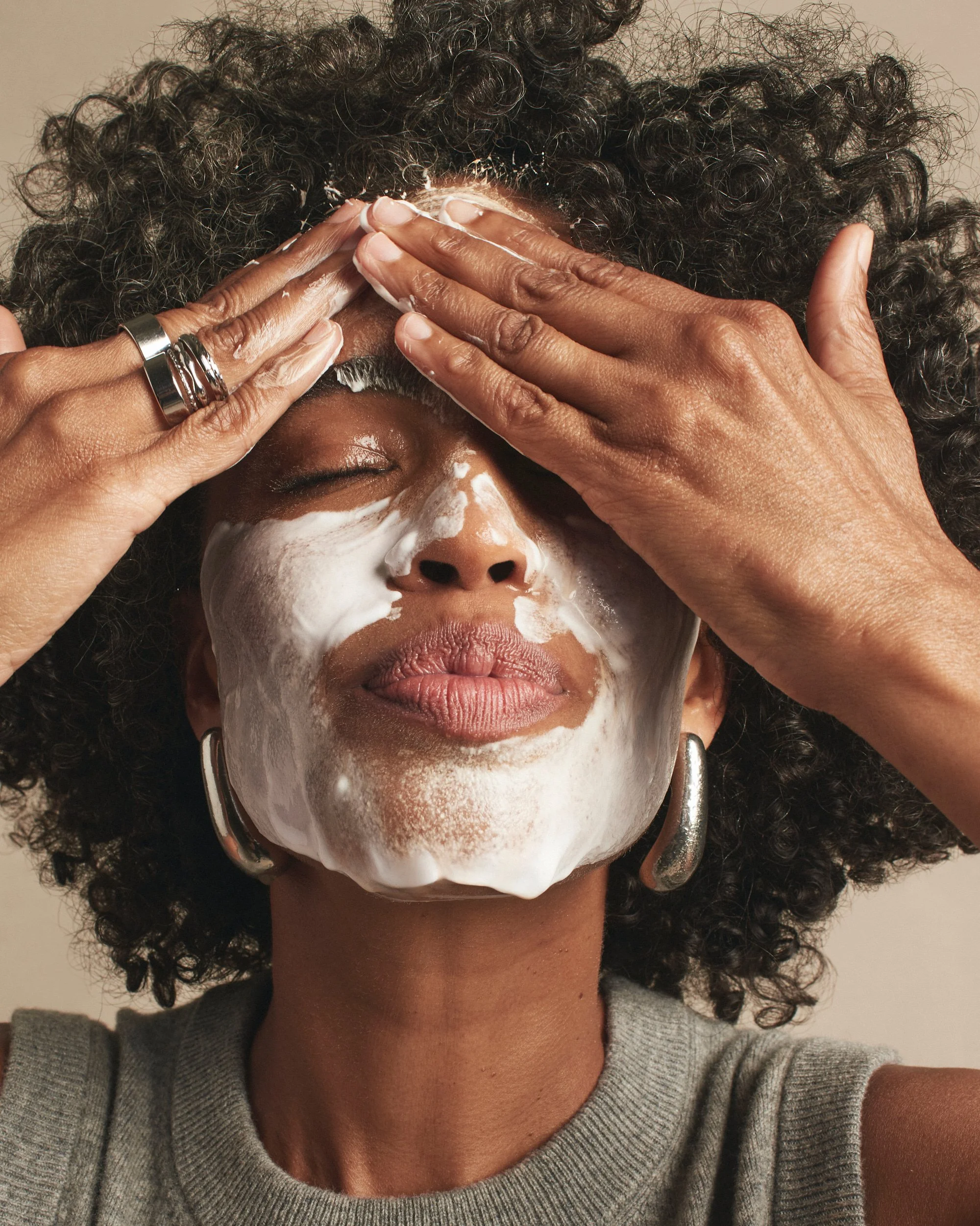 Joshua Pestka commercial beauty photography — Mary Kay TimeWise Repair campaign, model applying cleanser mask, hands framing face