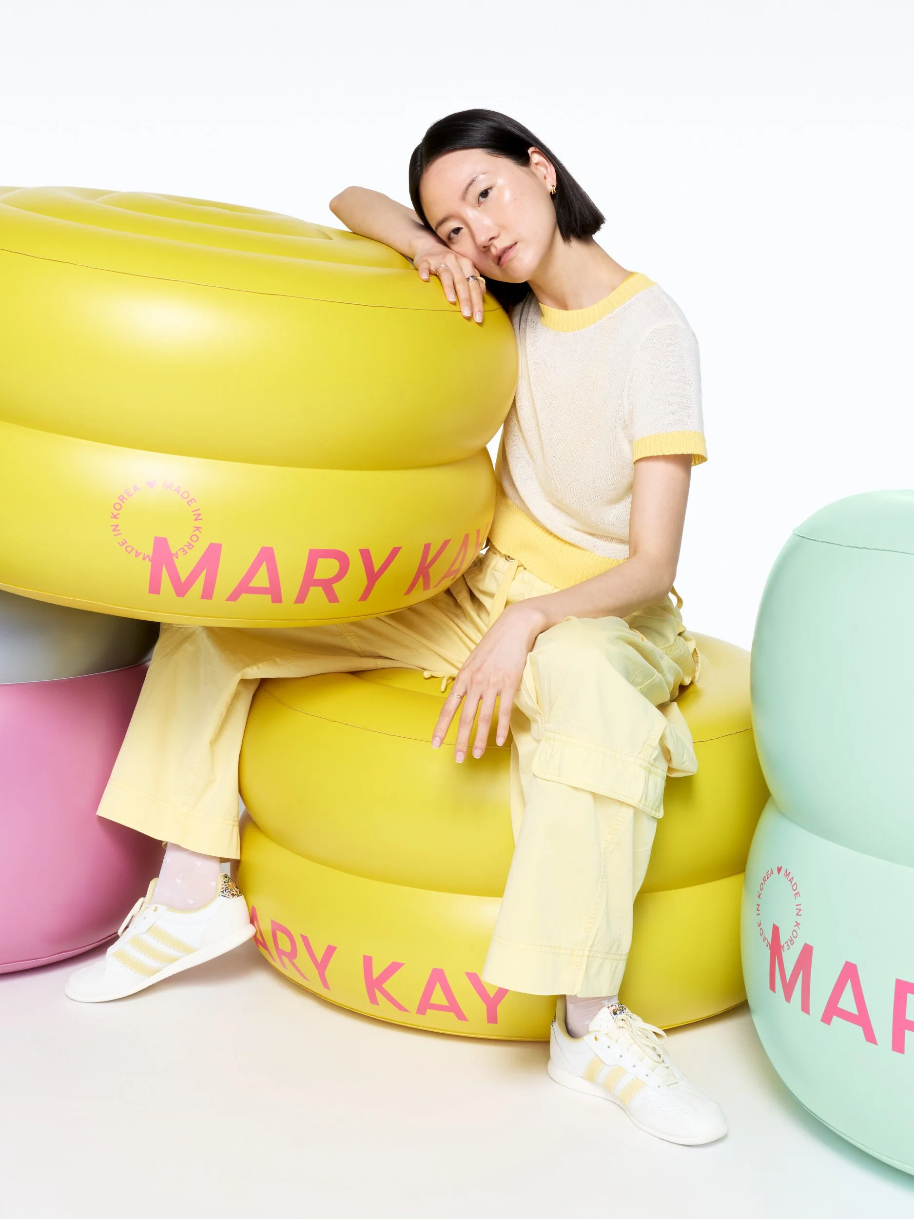 joshua-pestka-mary-kay-k-beauty-model-lounging-yellow-inflatable-jars.jpg