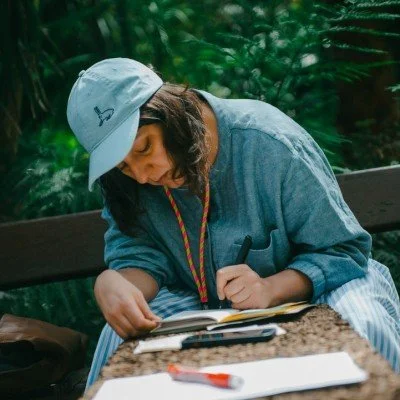 Kasia Zaniewska drawing in a book