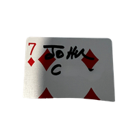 Playing card with a 7 of diamonds, handwritten message 'To H' and some doodles.