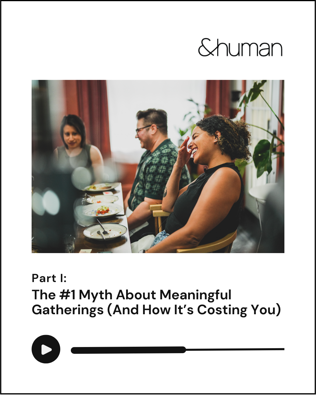 People sitting at a dining table, laughing and smiling during a meal, with plates of food and drinks in front of them.