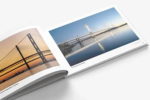 Open photo book displaying images of bridges over water at sunset and daytime.
