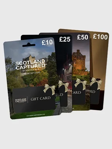 Four Scotland Captured gift cards with different denominations (£10, £25, £50, £100), each featuring scenic images of Scottish landscapes and landmarks, with a black lower section displaying the title and a small bow graphic.