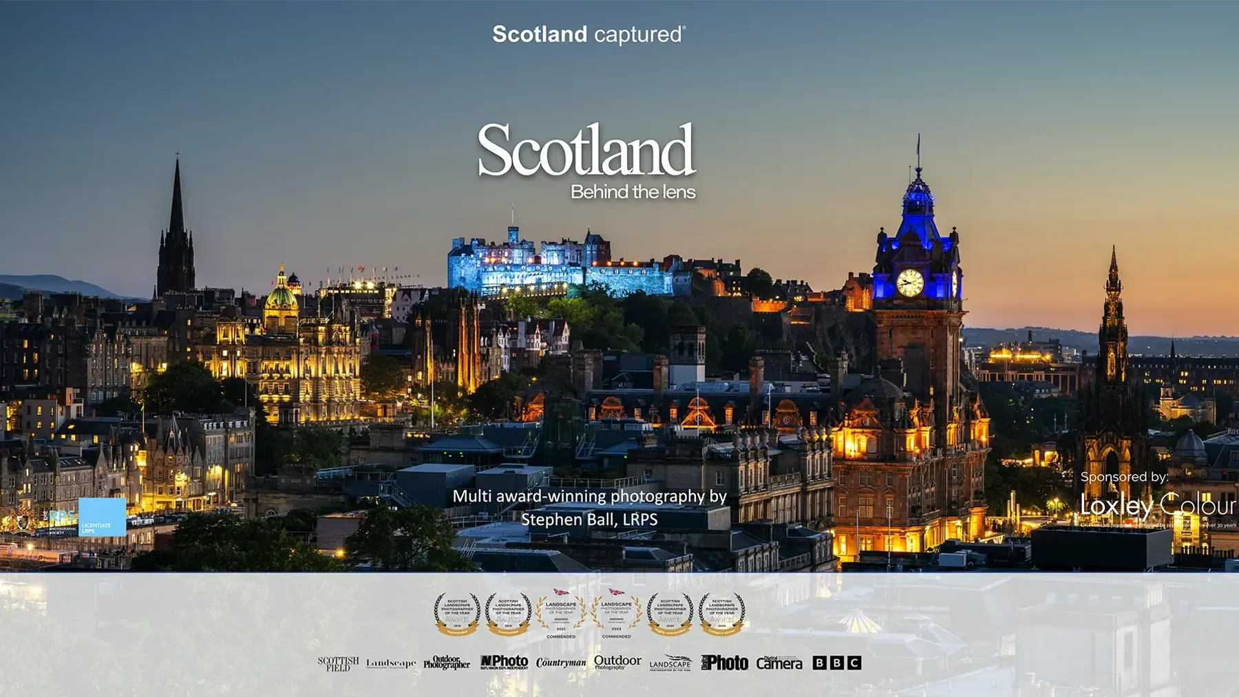 Nighttime view of the Edinburgh skyline in Scotland, illuminated buildings, historic clock tower, and Edinburgh Castle on a hill, with a clear sky in the background.