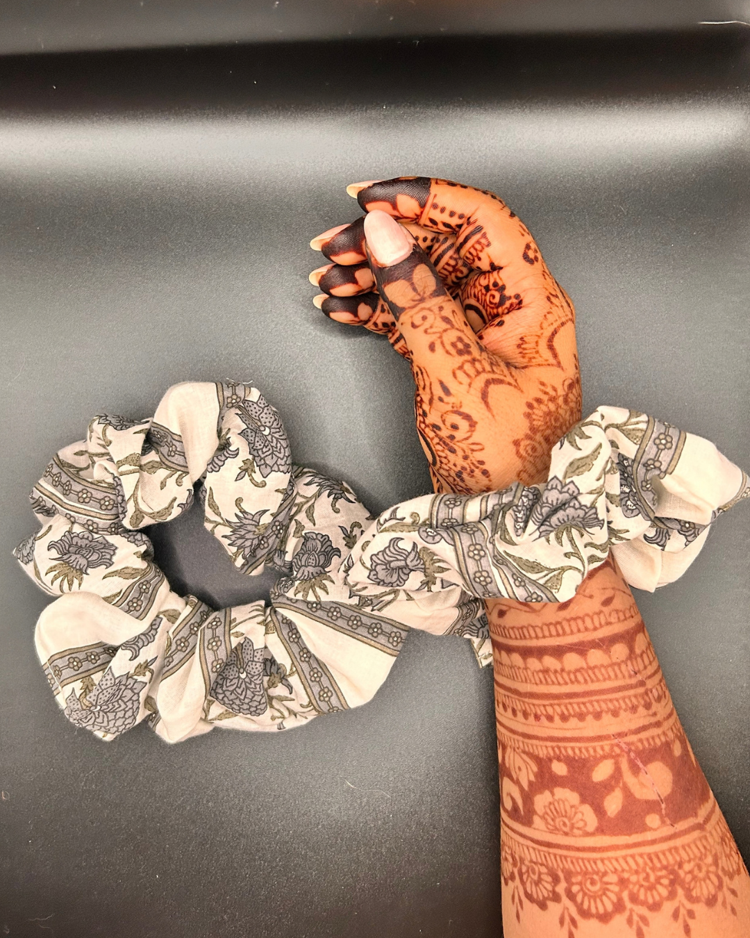 Ivory fabric scrunchie featuring grey botanical patterns