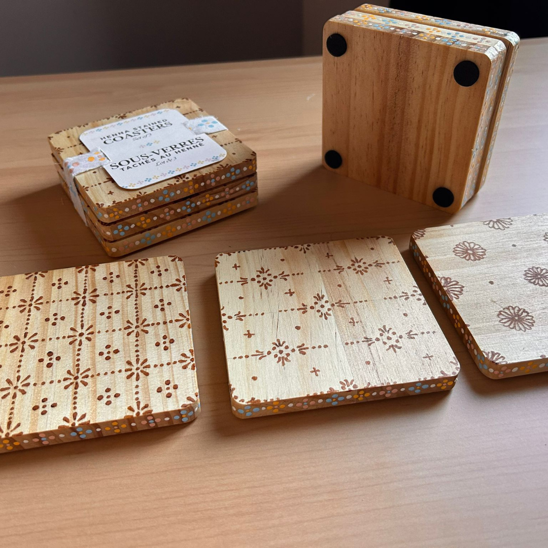Bottom, top, and side view of the set of 3 henna stained coasters.png