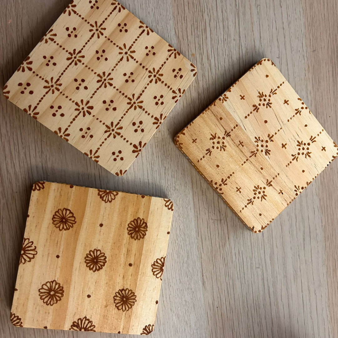 3 designs in each set of henna stained coaster.png
