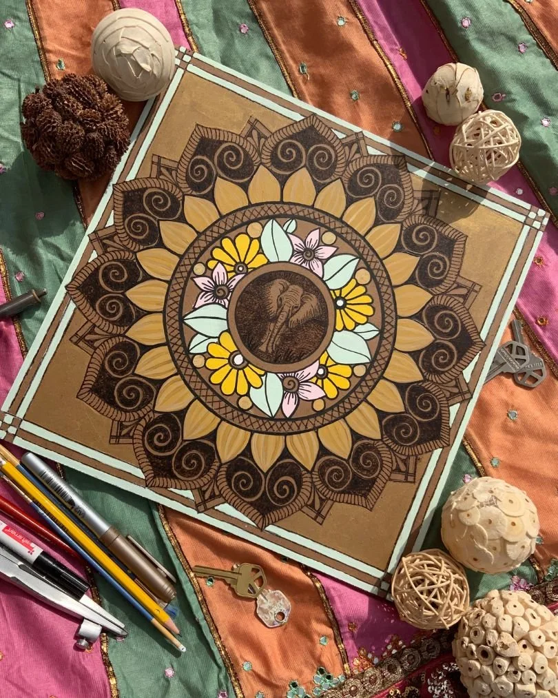 This image is of a burnt elephant mandala painted in with acrylic paints on MDF