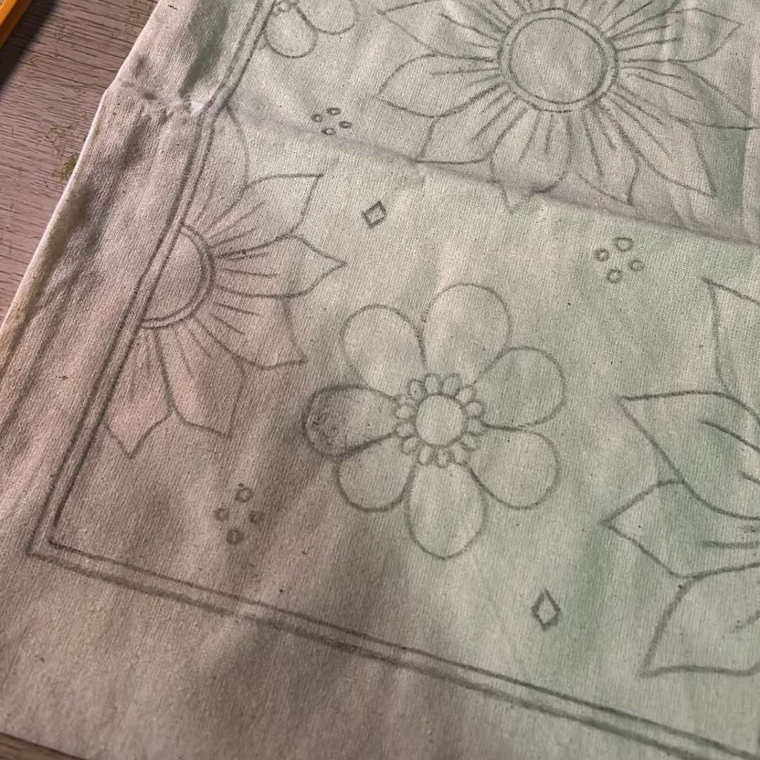Floral design sketched on a canvas tote bag for a customizable Sim.err Art Bar activity.