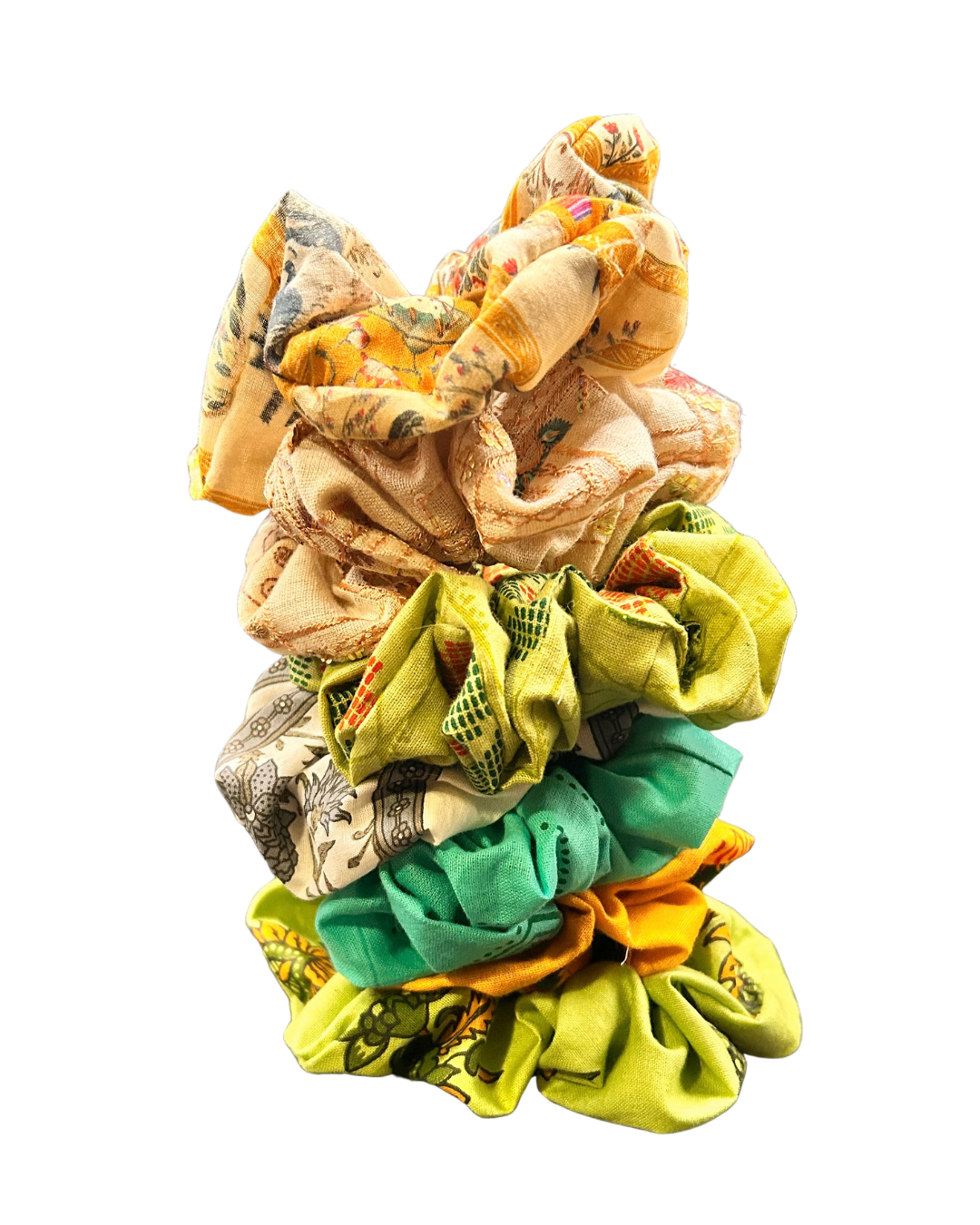 Stack of assorted colourful fabric scrunchies featuring floral and geometric designs
