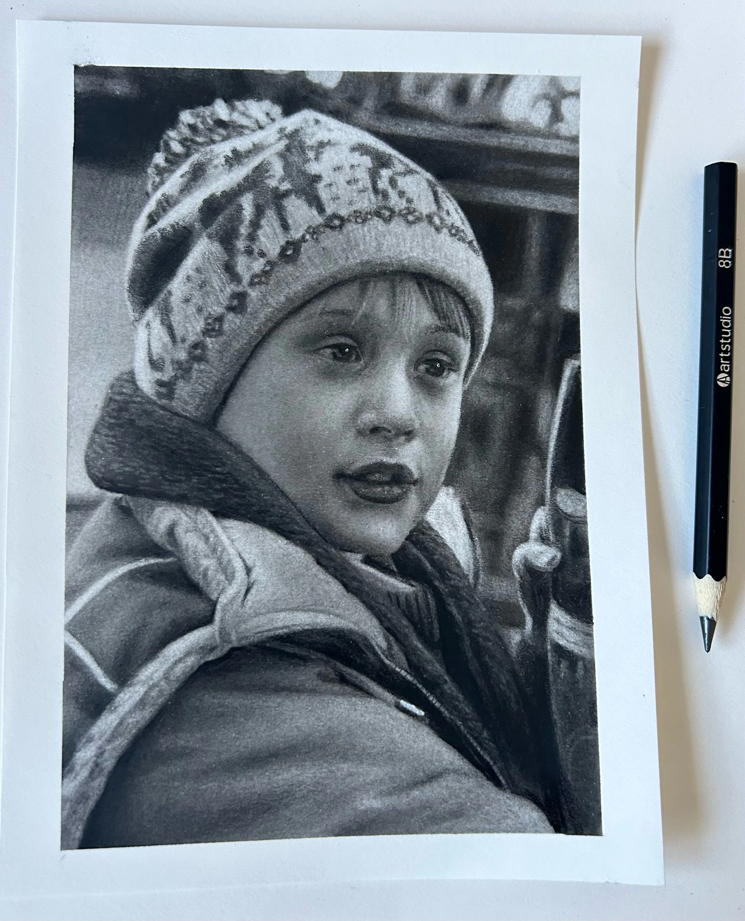 Black and white realistic drawing of boy from home alone, commission a portrait