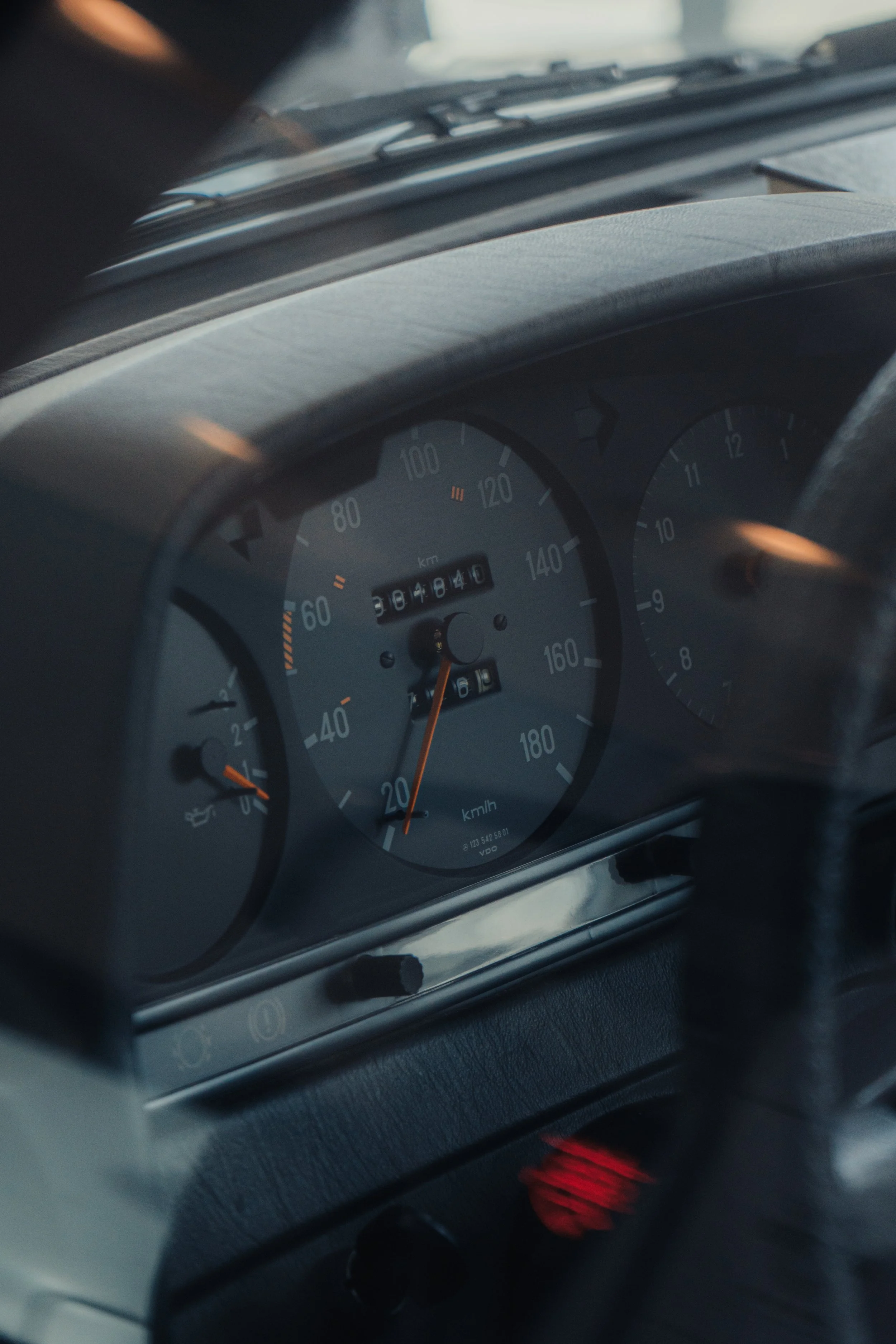 Close-up of a car dashboard showing the speedometer pointing to approximately 20 km/h, the odometer reading 308184 km, and the fuel and temperature gauges.