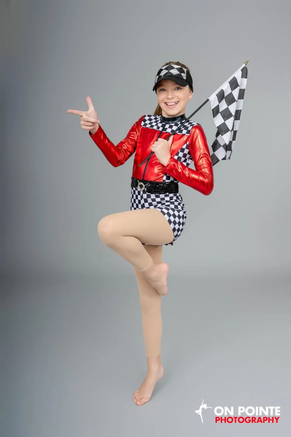 Person in racing-themed costume with a checked flag.