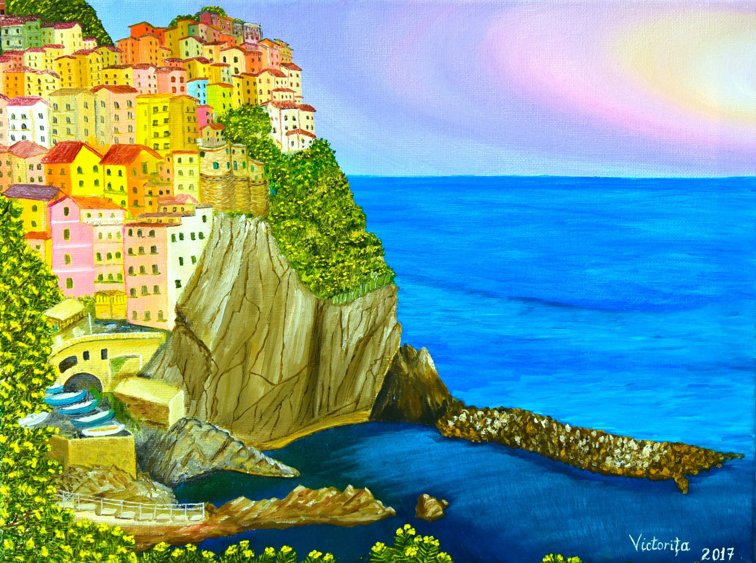 Manarola colorful houses built on a hillside overlooking the ocean with a staircase leading down to the water and a small rocky shoreline.
