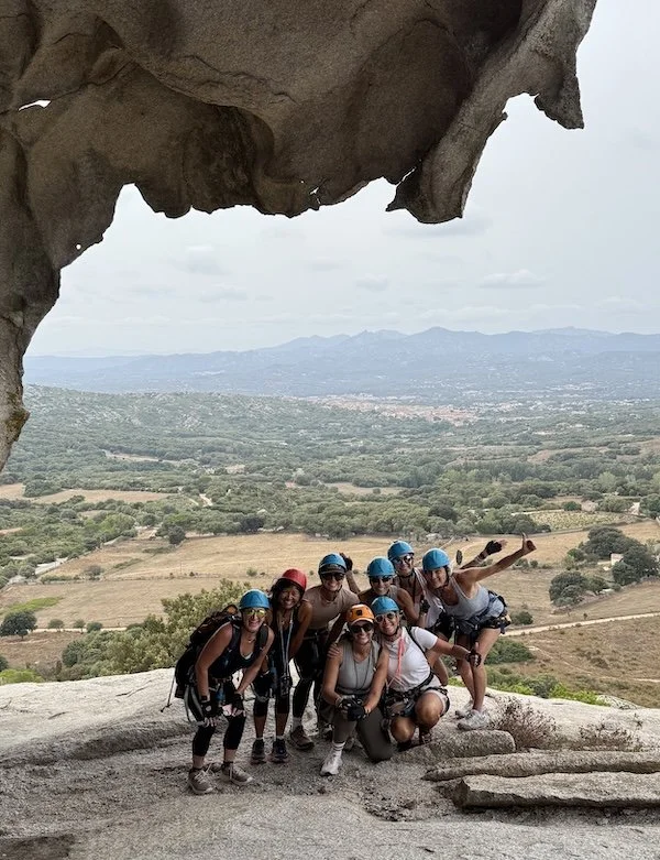 A group of mid-life women against the Sardinian landscape.
