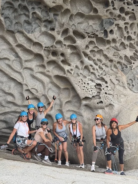 A group of women wall climbing in Sardinia.
