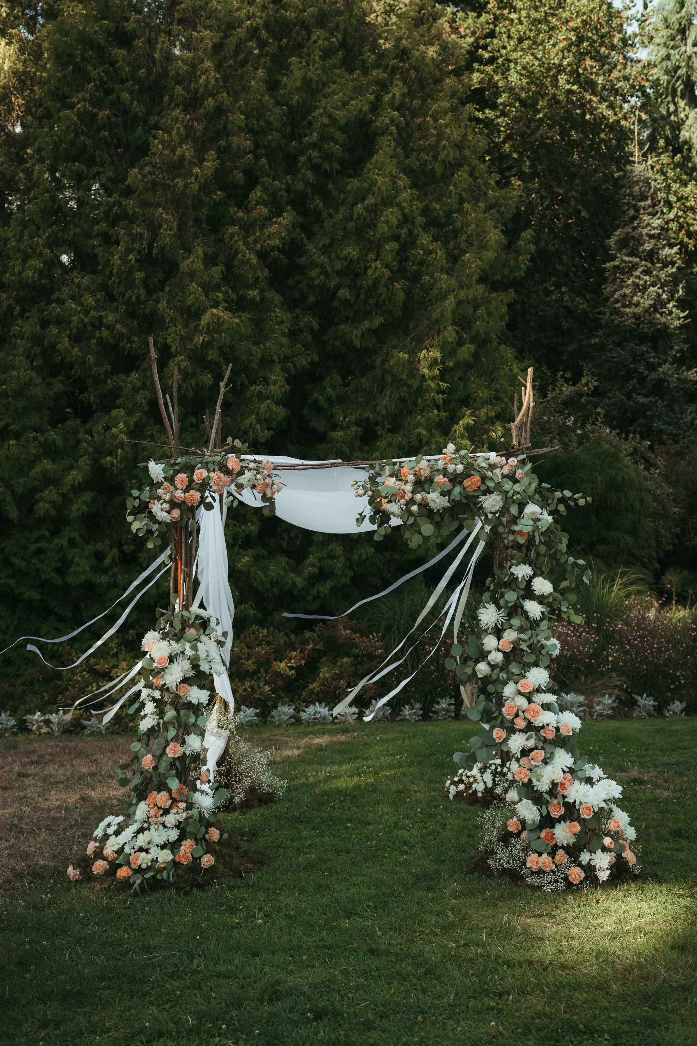 Wedding-arch pink peach and green on grass
