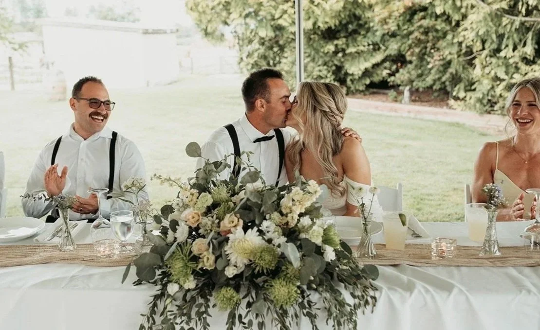 Bride and groom kissing floral bouquet