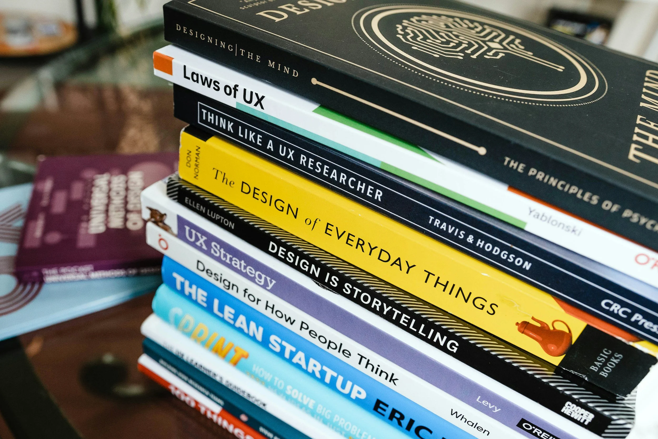 A colorful stack of books about user experience (UX) strategy, storytelling, and design