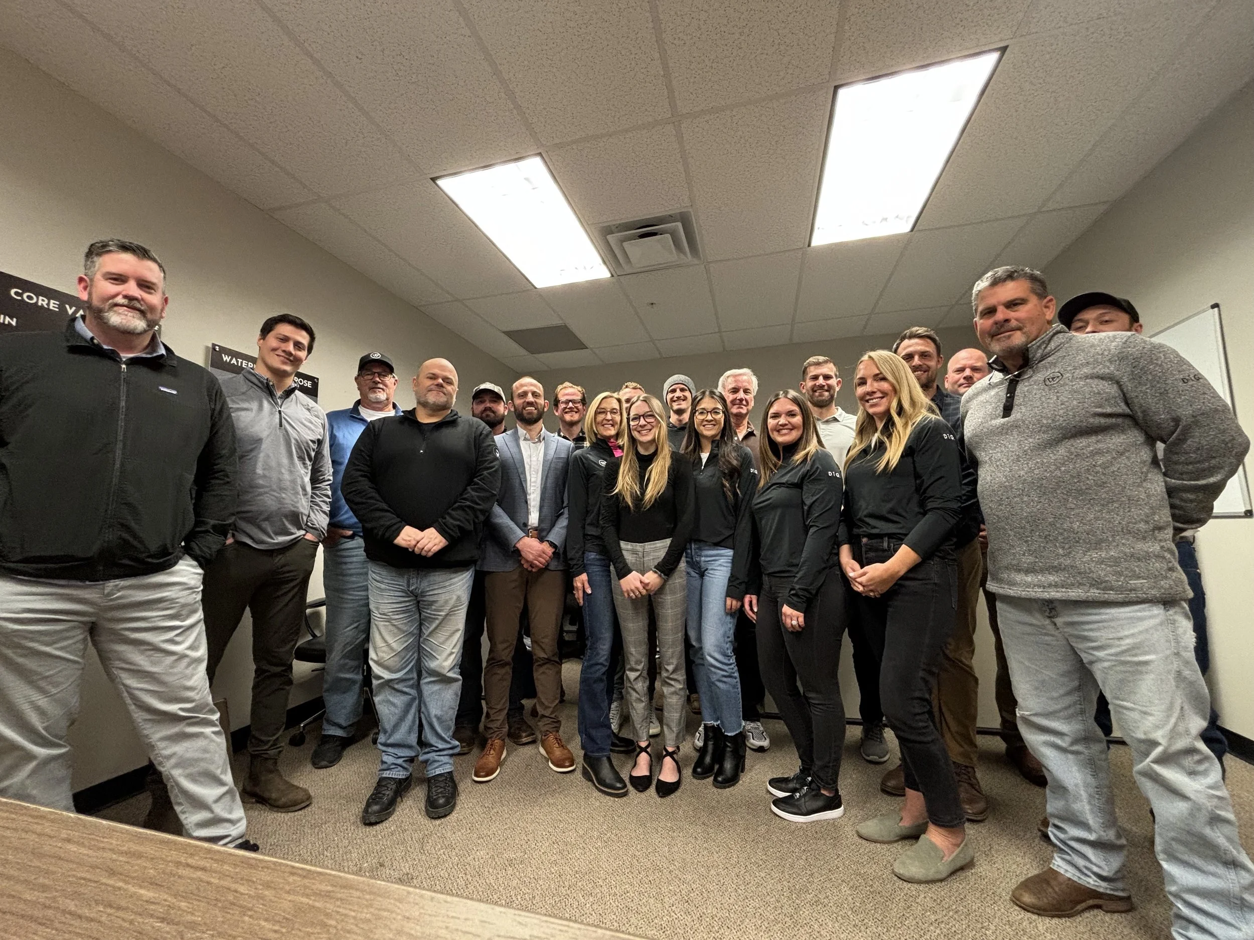 Watermark Companies and Rhino Residential employees standing in an office conference room, posing for a photograph.