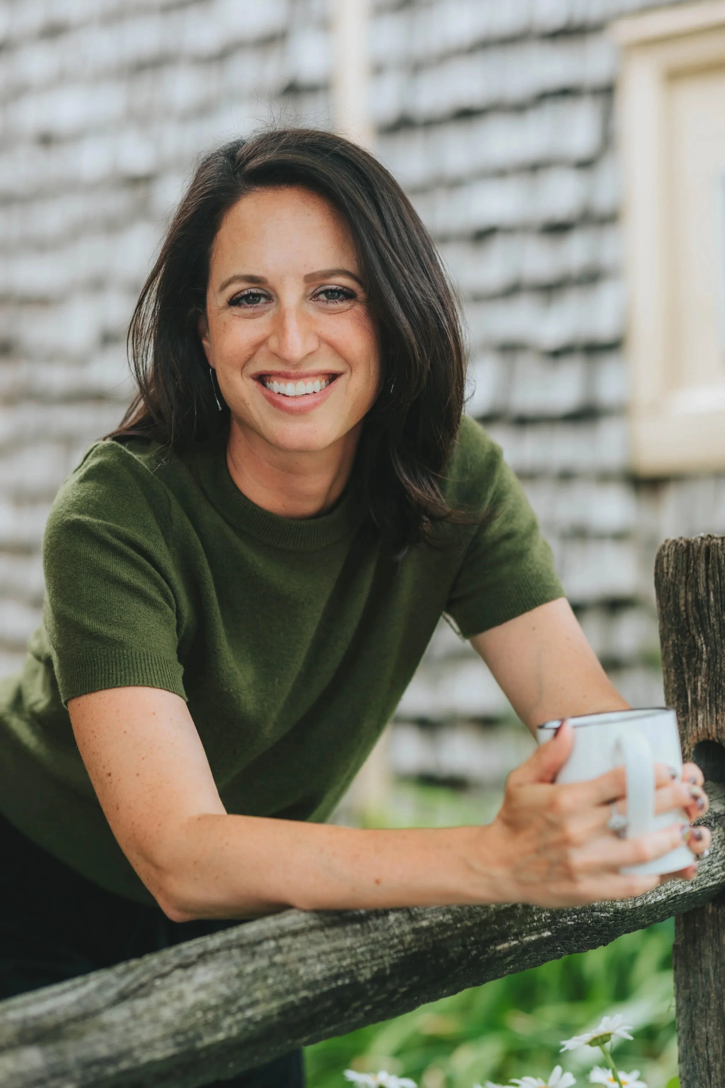 Jacqueline Laurenzi, EFT couples therapist, reflecting outdoors with coffee