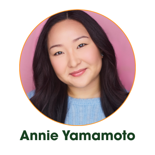 A young woman with long dark hair, smiling and winking, wearing a blue sweater against a pink background.