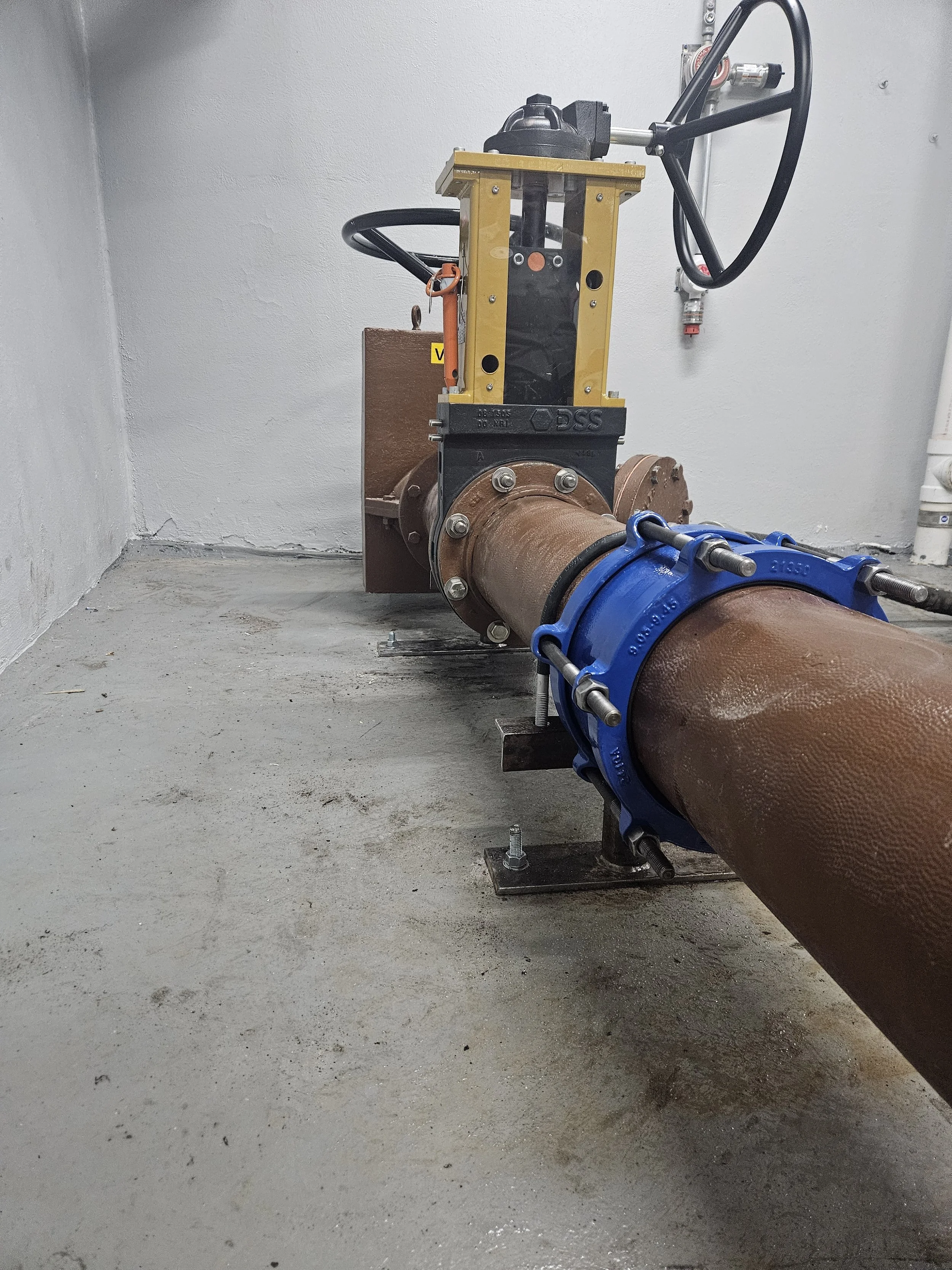 Underground pipe with valve and machinery for water or gas flow. pipework, glass lined pipe, poly pipe.