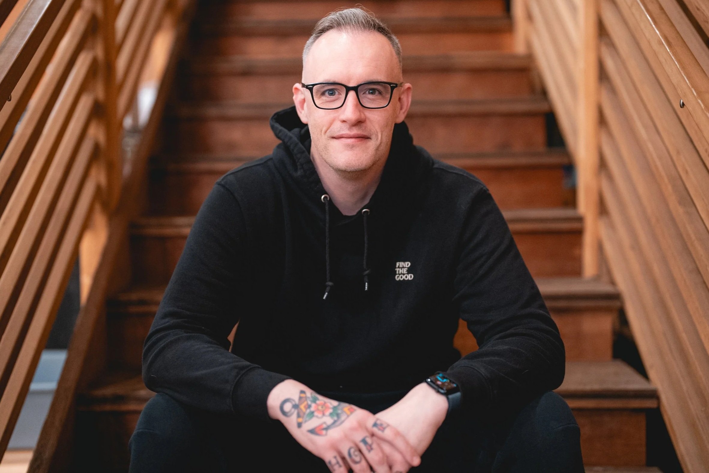 Chris sitting on a stairwell