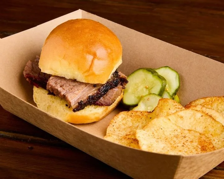 Brisket slider with house made potato chips made from the tallow they render from the trim of Brandt Family Farms brisket along with house made bread and butter pickles